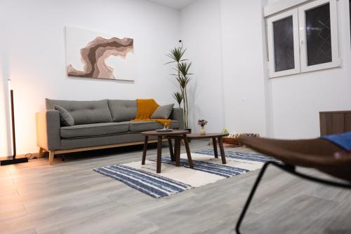 a living room with a couch and a table at Casa Lola Sanlucar de Barrameda in Sanlúcar de Barrameda