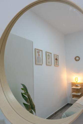 a large round mirror in a room with a bed at Casa Lola Sanlucar de Barrameda in Sanlúcar de Barrameda