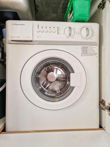 a white washing machine sitting in a room at Seasons stay Bansko in Bansko