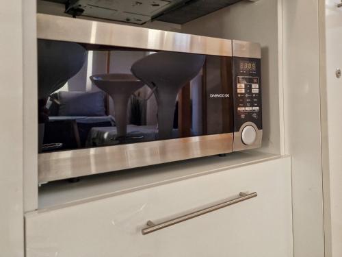 a microwave on top of a cabinet in a kitchen at Seasons stay Bansko in Bansko