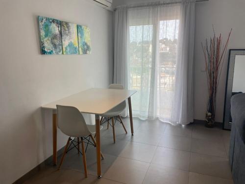 a dining room with a table and two chairs at Gloria Seaviews in Manacor