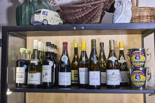 a shelf with a bunch of wine bottles on it at La Flambée in Sennecey-lès-Dijon