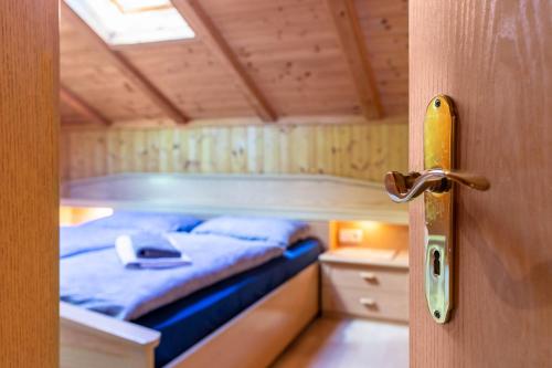 a door to a bedroom with a bed in it at Stifterhof App Mathilda in Rio Bianco