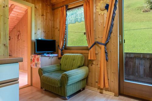 a living room with a chair and a television at Stifterhof App Mathilda in Rio Bianco