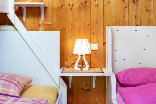 a room with two beds and a table with a lamp at Stifterhof App Mathilda in Rio Bianco