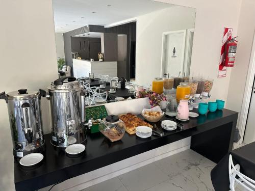 una barra de cocina con productos para el desayuno y zumo de naranja en Hotel Bermudas, en Mar del Plata
