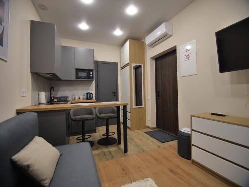 a small kitchen with a table and a counter at Smart House Apartments in Lviv