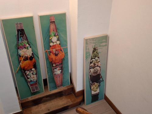 a group of three vases on display on a wall at La Vie en Rose in Verviers