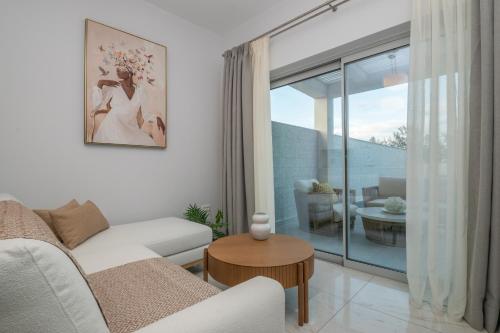 a living room with a couch and a table at Camelia Luxury Suites in Psarou