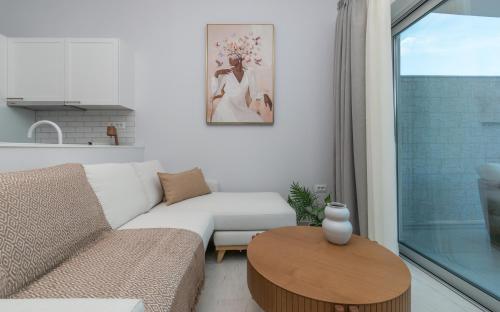 a living room with a couch and a table at Camelia Luxury Suites in Psarou