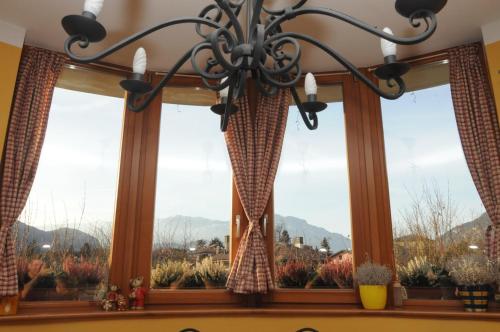 a chandelier hanging over a window with a view at A&B Le Terrazze del Sale' - Apartments in Trento