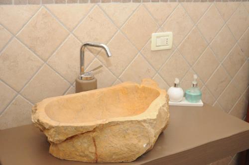 a stone sink on a counter in a bathroom at A&B Le Terrazze del Sale' - Apartments in Trento