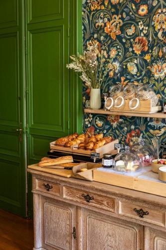 a table with bread and pastries on top of it at Hôtel du Mail in Angers