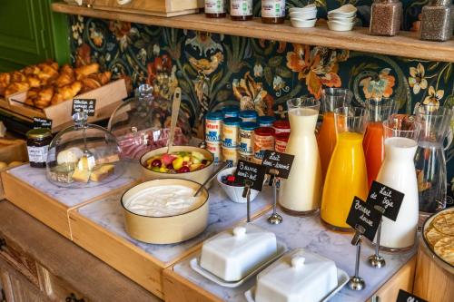 a display of milk and other food items on a table at Hôtel du Mail in Angers