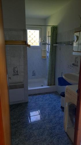 une salle de bain avec une baignoire et un lavabo et une baignoire dans l'établissement Lieux-au-lac, à Augignac
