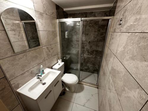 a bathroom with a toilet and a shower and a sink at Kyrenia center, 2 bedroom, 1 living room, residential apartment in Kérynia