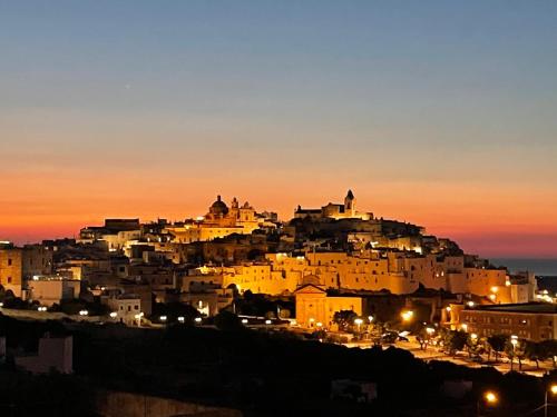 a view of a city at night with lights at La terrazza di Lillo in Carovigno