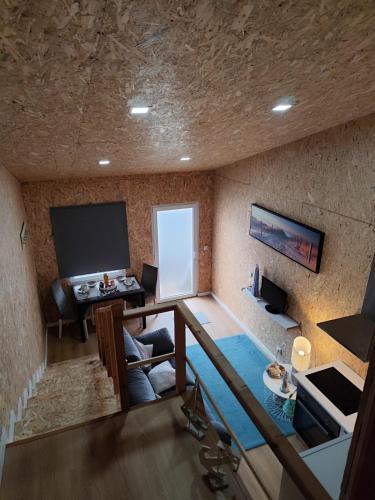 a room with a stone wall with a table and a television at CASA DO BENTO - Rustic Cozy Loft, Vila do Conde in Fajozes