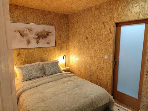 a bedroom with a large bed and a window at CASA DO BENTO - Rustic Cozy Loft, Vila do Conde in Fajozes