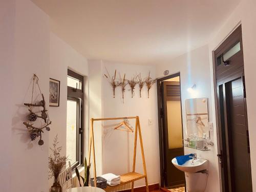 a bathroom with a toilet and a sink and a mirror at BắpHouseHomestay in Da Lat