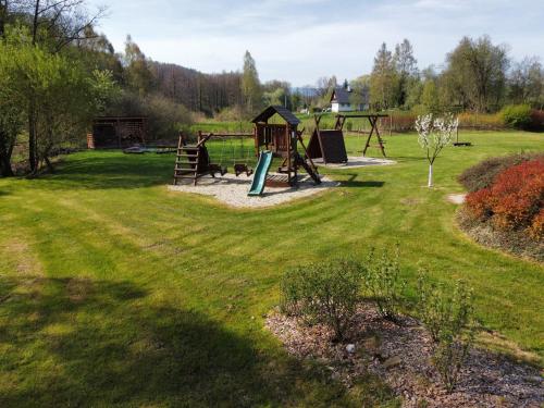 a park with a swing set and a playground at Penzion Terezka in Králíky