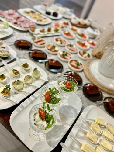 a table with many plates of food on it at Piano in Nowy Sącz