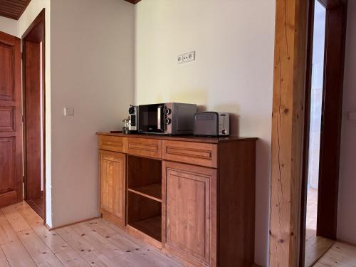 a kitchen with two microwaves on a wooden cabinet at Penzion Terezka in Králíky