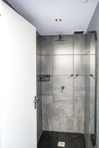 a shower with a glass door in a bathroom at Las Palmas Rooftop Hostel in Las Palmas de Gran Canaria