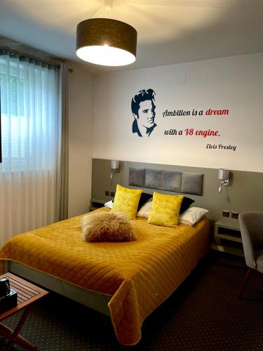 a bedroom with a bed with a sign on the wall at Piano in Nowy Sącz