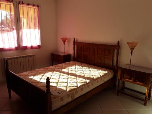 une chambre avec un lit et deux fenêtres dans l'établissement Rez de villa SAINT RAPHAËL, à Saint-Raphaël