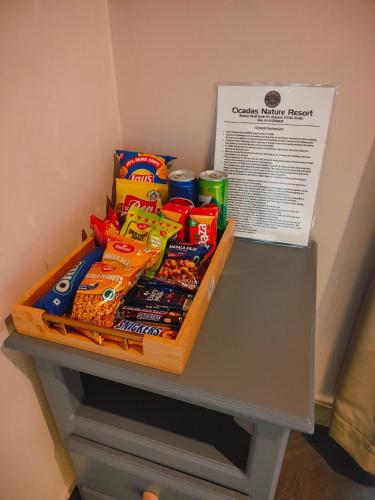 a basket of chips and other snacks on a table at Cicadas Nature Resort - A Frame cottages in Wayanad