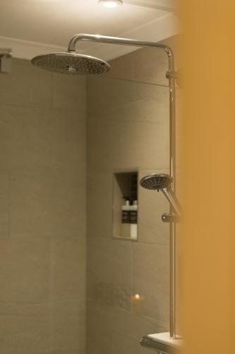 a bathroom with a shower with a glass door at The Heronry Hideaway with luxury hot tub in Ballachulish