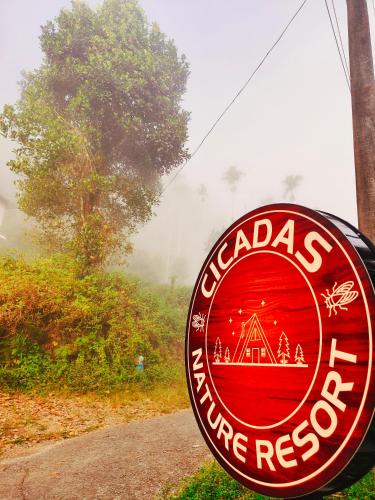 a sign for a wine restaurant on the side of a road at Cicadas Nature Resort - A Frame cottages in Wayanad