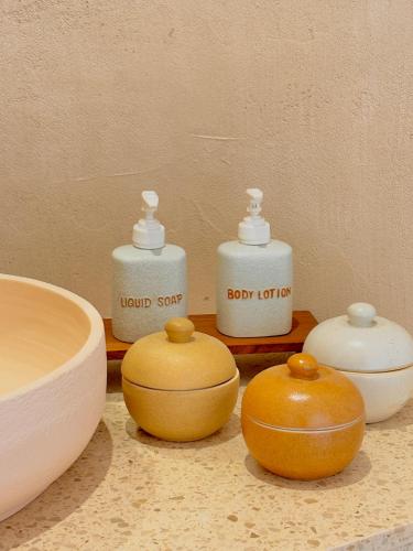 a group of five soap bottles sitting on a counter at Rest Sea Resort Koh Kood in Ko Kood