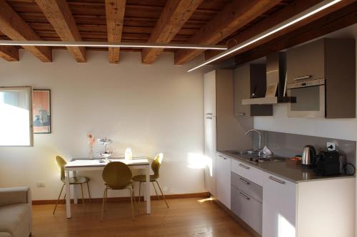 a kitchen with a table and chairs in a room at Residenza Della Samaritana in Verona