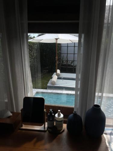 a room with a view of a swimming pool through a window at Rest Sea Resort Koh Kood in Ko Kood