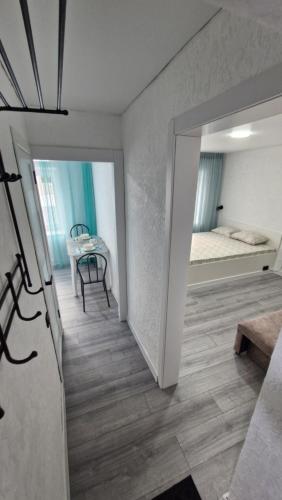 a room with a hallway with a bed and a mirror at Marinad 1-ком Квартира в Центре города in Petropavlovsk