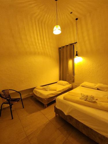 Кровать или кровати в номере Casa Carmesí Zapatoca