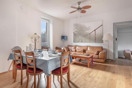 un salon avec une table, des chaises et un canapé dans l'établissement Sur le Port du Croisic - Appartement pour 4, au Croisic