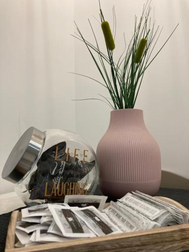 a table with a vase and newspapers and a table with a vase at La Casetta in Grammichele