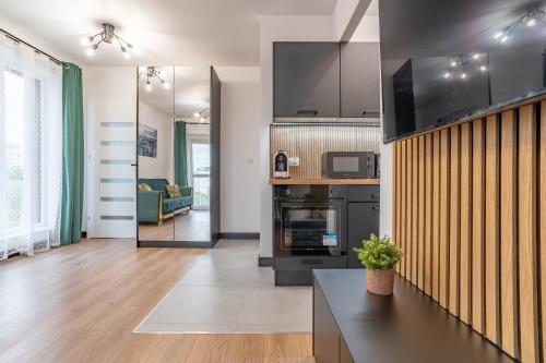 a large living room with a kitchen and a living room at WrocApartments WestCenter - Parking Free in Wrocław