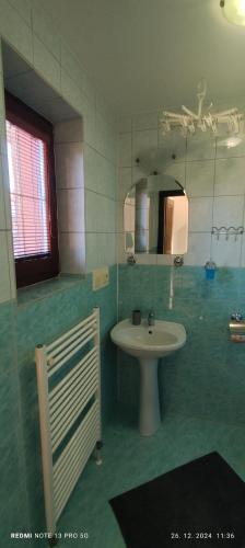 a bathroom with a sink and a mirror at Guest House Zuzana in Habovka