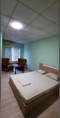 a bedroom with a large bed in a room at Хотел Елит in Kostinbrod