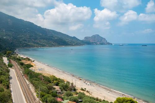a view of a beach and the ocean at CefalHome - KEFAHELION in SantʼAmbrogio