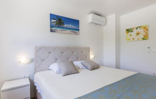 1 dormitorio con 1 cama con colcha blanca y 2 almohadas en Beautiful Villa Ana with pool in Labin, en Labin