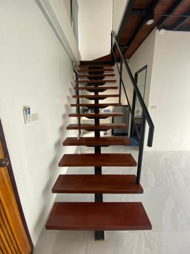 a staircase in a house with wooden steps at Scenery Sunrise in Chaweng Noi Beach