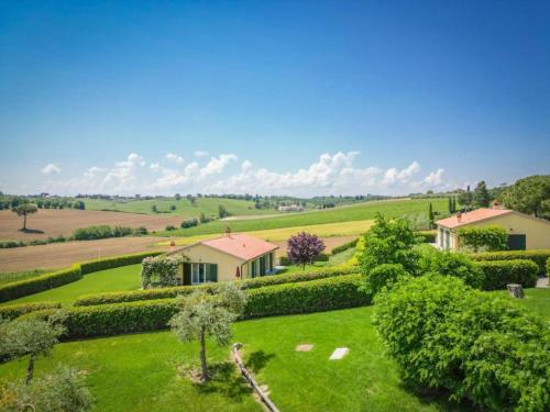 an aerial view of a house in a green field at Borgo Syrah in Cortona