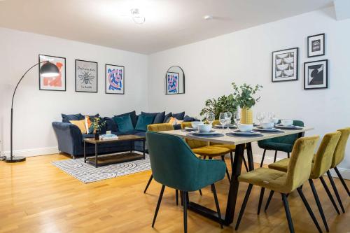 a living room with a table and a couch at Canal Street Apartment in Manchester