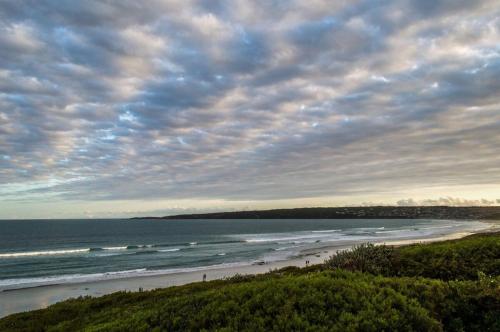 a view of a beach with people in the water at Seafront! Home in Boggomsbay in Boggomsbaai