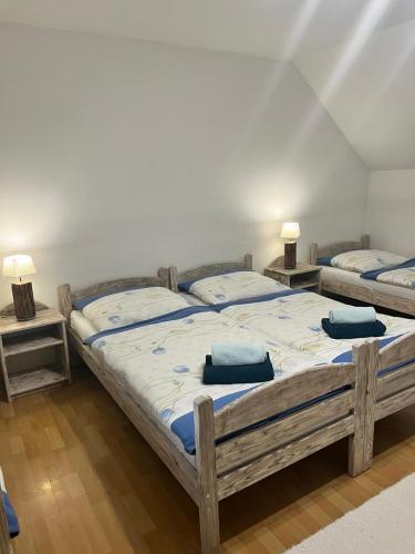 a bedroom with two beds with blue pillows on them at Guest House Zuzana in Habovka